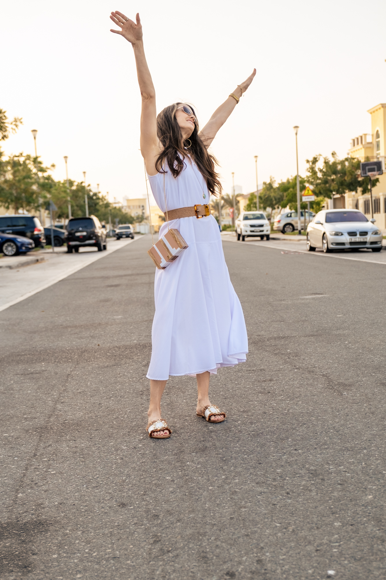 Standing in the street, hands up, face to the sky smiling