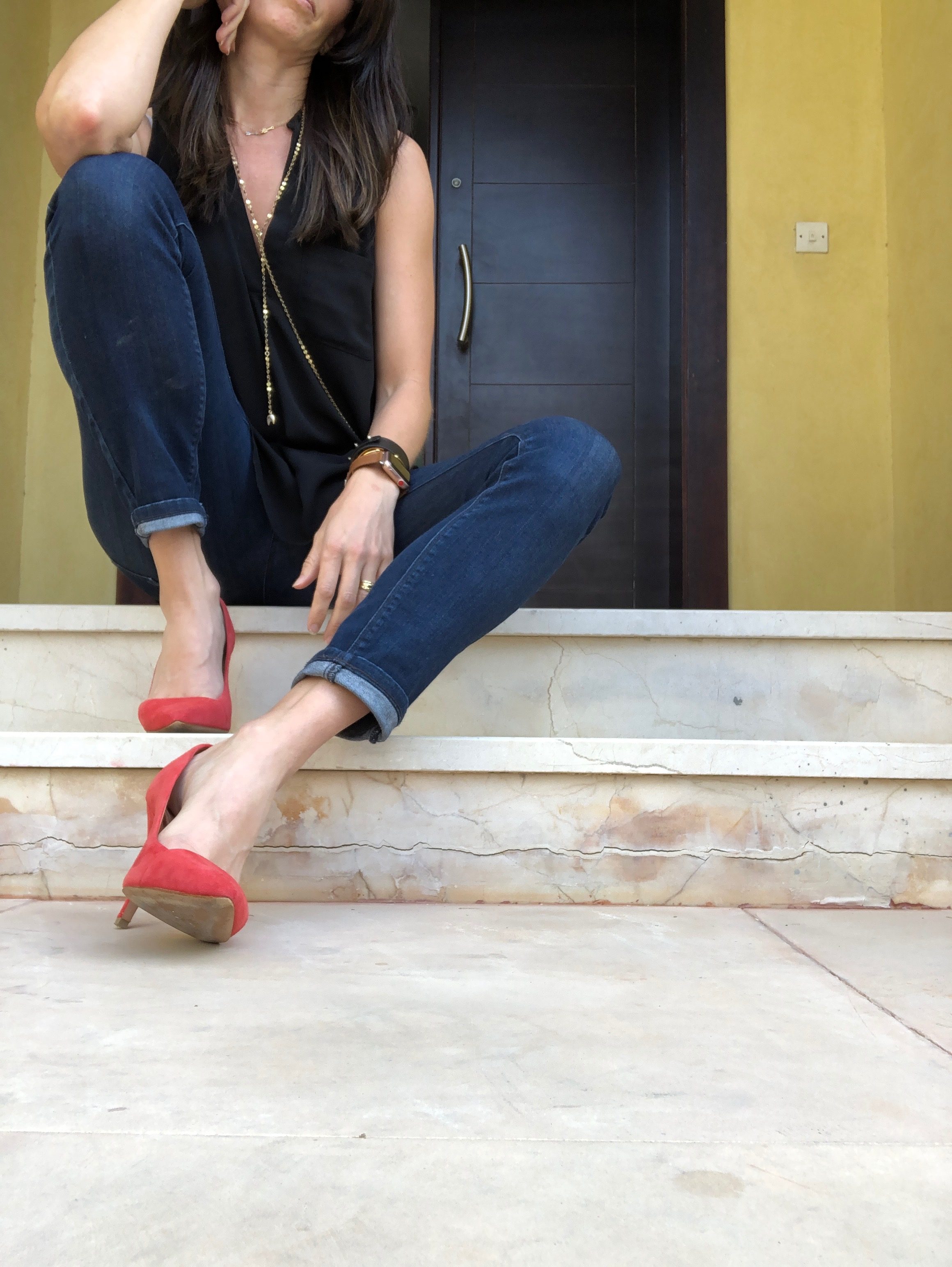 A woman sitting on the steps of her house.