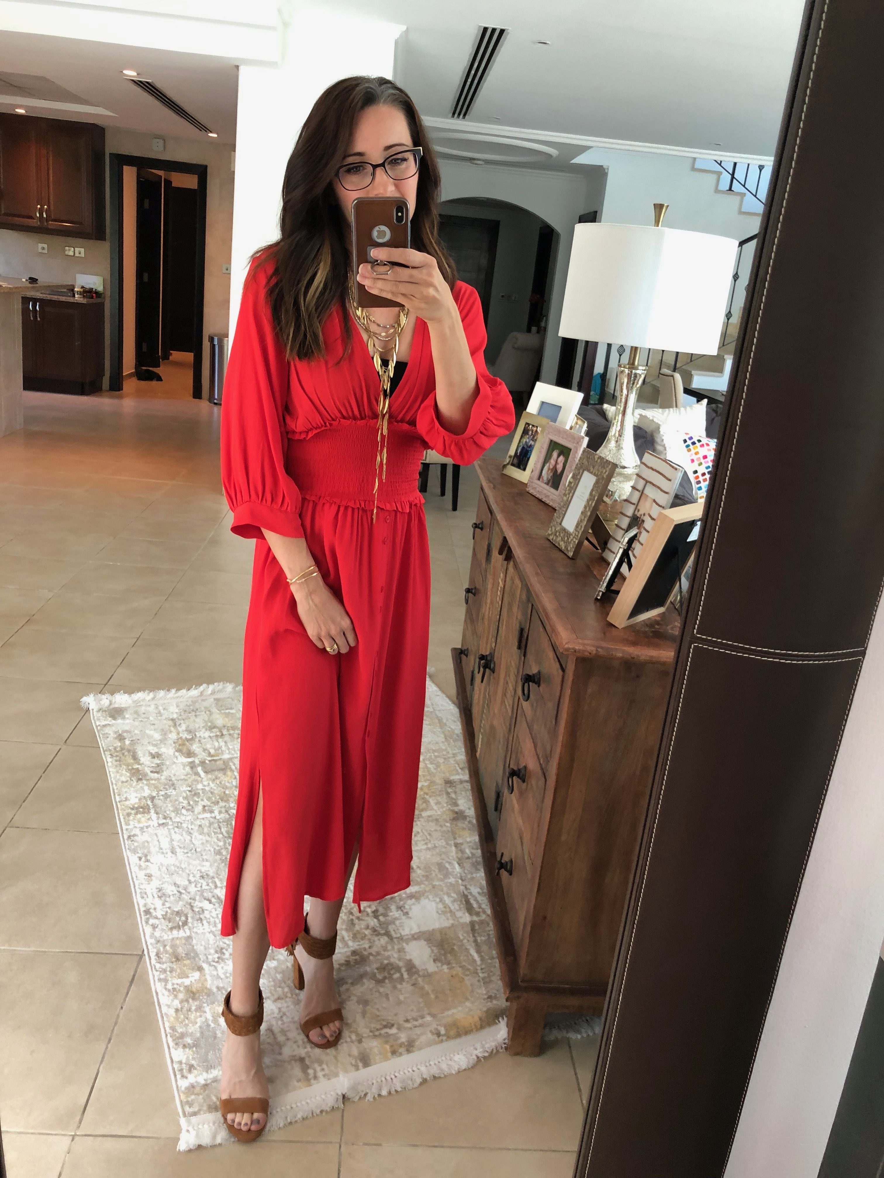 A woman in red dress taking a selfie