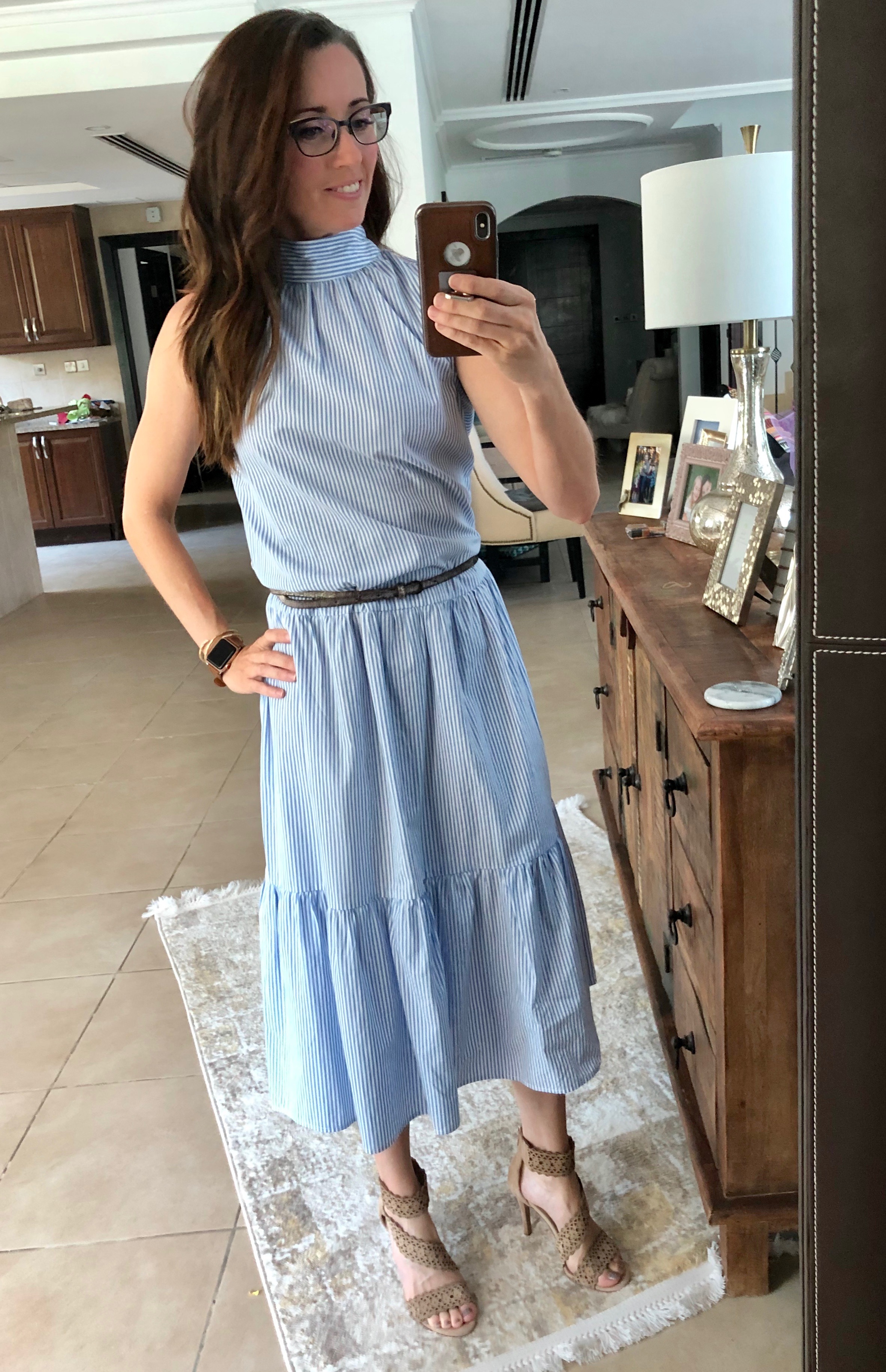 A woman taking a selfie in front of the mirror.