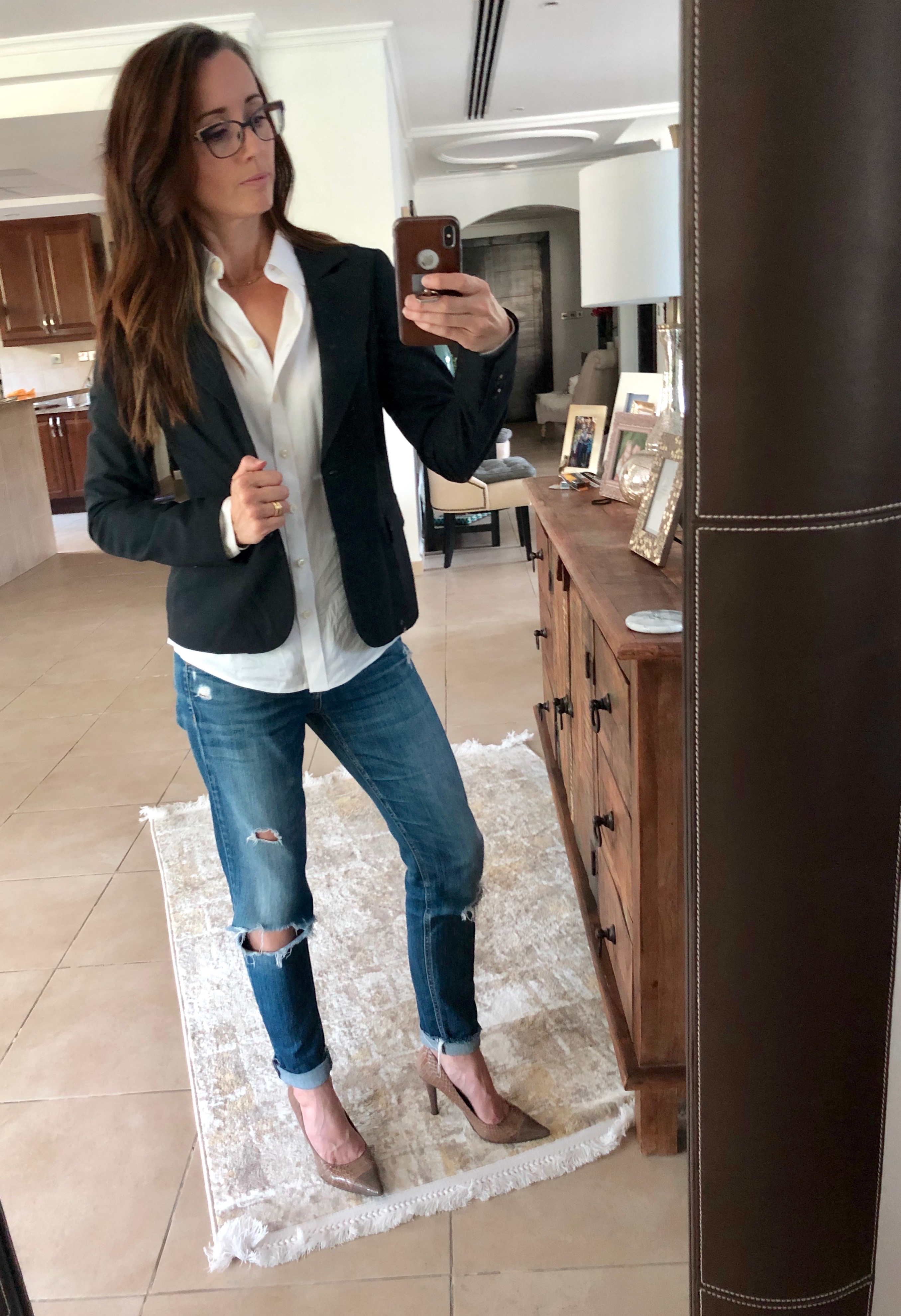 A woman taking a selfie in front of the mirror.