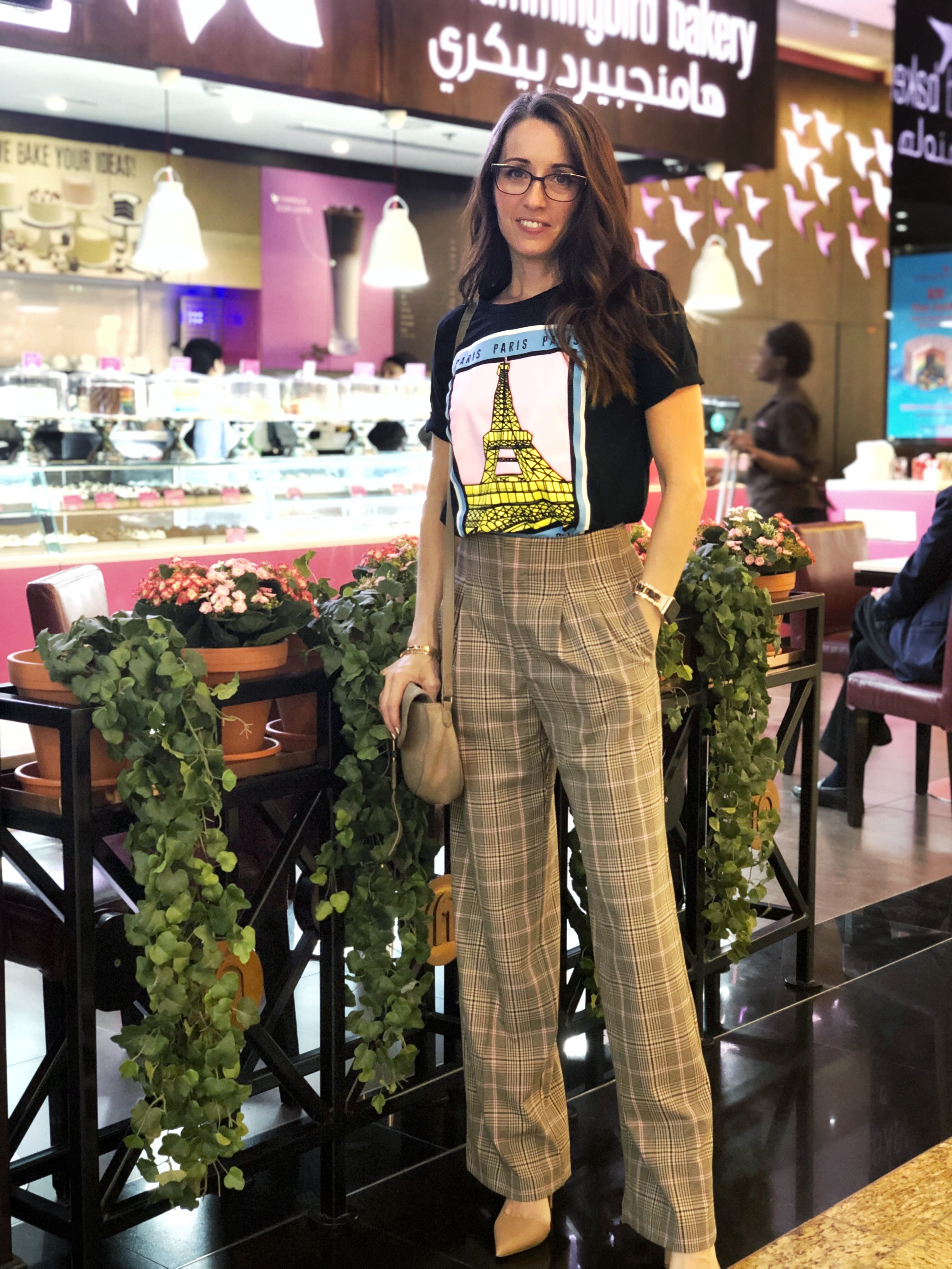 A woman standing in front of some tables