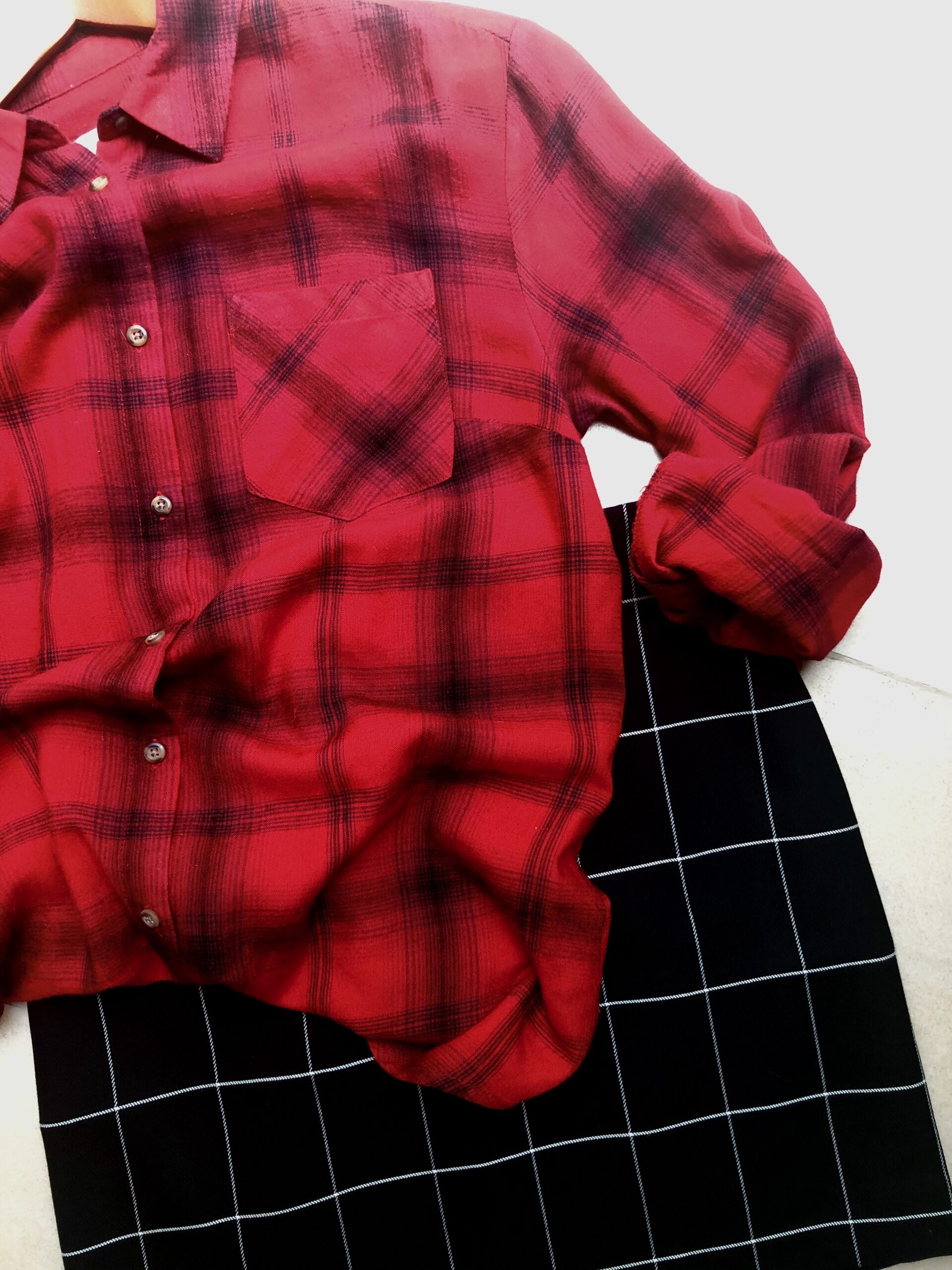 A red plaid shirt and black checkered skirt.